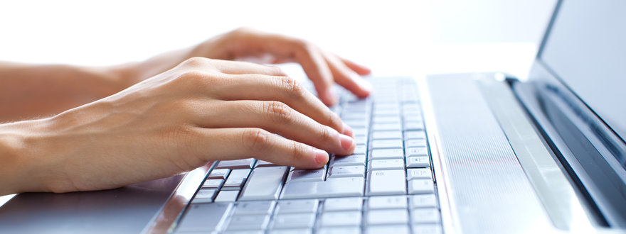 Male hands typing on the laptop