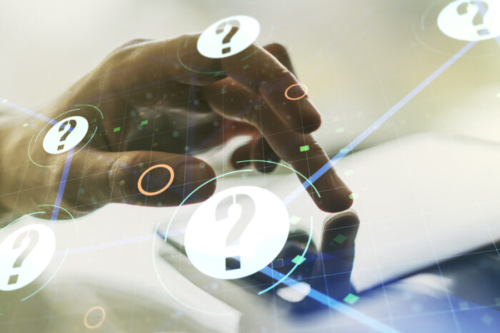 Creative abstract question mark sketch and hand working with a digital tablet on background, FAQ and research concept. Double exposure